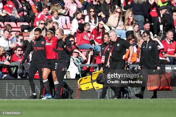 Gabrielle George of Manchester United receives medical treatment and is substituted off during the Barclays Women's Super League match between...