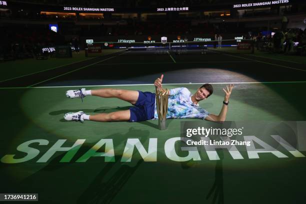 Hubert Hurkacz of Poland poses with the winner's trophy after defeating Andrey Rublev of Russia during the Men's singles final match on Day 14 of the...