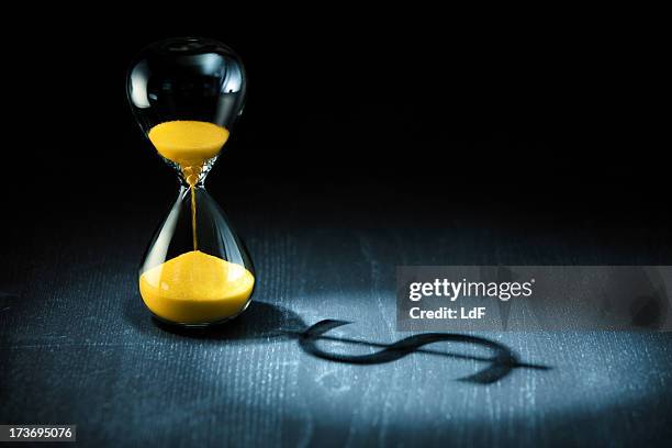 hourglass and dollar shadow - time is money stock pictures, royalty-free photos & images