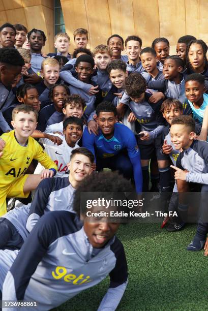 Tottenham Hotspur Youth Academy Players pose for a photo with Jude Bellingham of England at Spurs Lodge on October 14, 2023 in London, England.