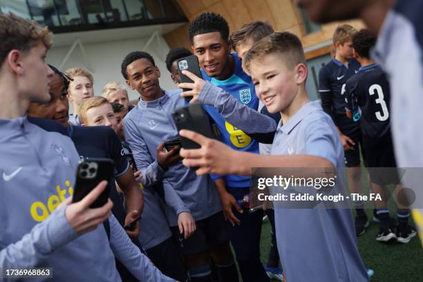 Tottenham Hotspur Youth Academy Players pose for a photo with Jude Bellingham of England at Spurs Lodge on October 14, 2023 in London, England.