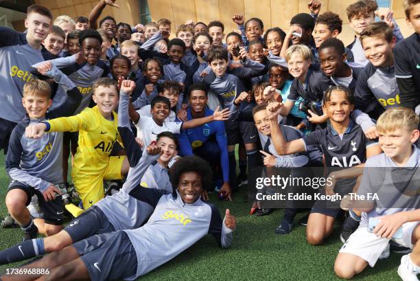 Tottenham Hotspur Youth Academy Players pose for a photo with Jude Bellingham of England at Spurs Lodge on October 14, 2023 in London, England.