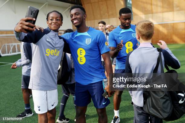 Eddie Nketiah of England poses for a photo with a Tottenham Hotspur Youth Academy Player at Spurs Lodge on October 14, 2023 in London, England.
