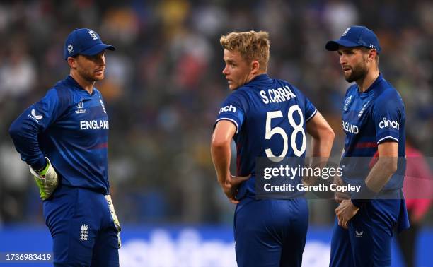 Jos Buttler, Sam Curran and Chris Woakes of England interact during the ICC Men's Cricket World Cup India 2023 between England and Afghanistan at...