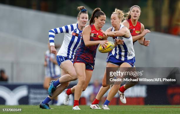 Kate Hore of the Demons is tackled by Kate Shierlaw of the Kangaroos during the 2023 AFLW Round 08 match between Narrm and The North Melbourne...
