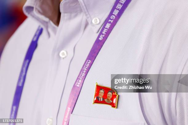 North Korea's coach Ri Yu Il's badge which printing the portrait of Kim Il-sung and Kim Jong-un during the 19th Asian Game Women's gold medal match...