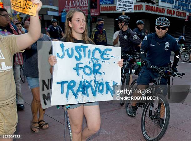 Protestors angry at the acquittal of George Zimmerman in the death of black teen Trayvon Martin march through the streets of downtown Los Angeles,...