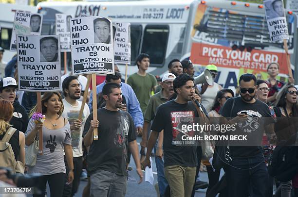 Demonstrators protest peaceful marching on the street of downtown Los Angeles against the acquittal of George Zimmerman in the shooting death of...