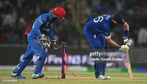 Joe Root of England is bowled by Mujeeb ur Rahman of Afghanistan during the ICC Men's Cricket World Cup India 2023 between England and Afghanistan at...