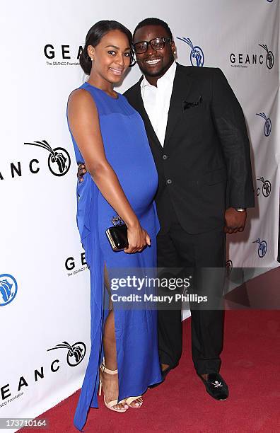 Player LeRon McClain and Dominque Wade arrive at The GEANCO Foundation's "Impact Africa" Fundraiser at Bootsy Bellows on July 16, 2013 in West...