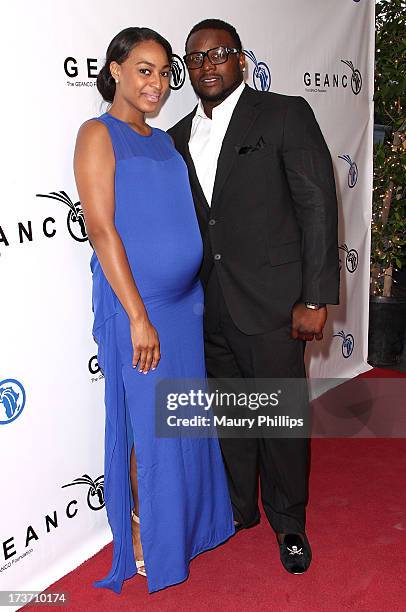 Player LeRon McClain and Dominque Wade arrive at The GEANCO Foundation's "Impact Africa" Fundraiser at Bootsy Bellows on July 16, 2013 in West...