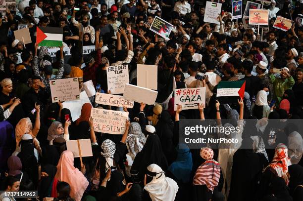 Indian Muslims shout slogans as they participate in a public gathering to show solidarity with the Palestinians in Gaza who have been affected due to...