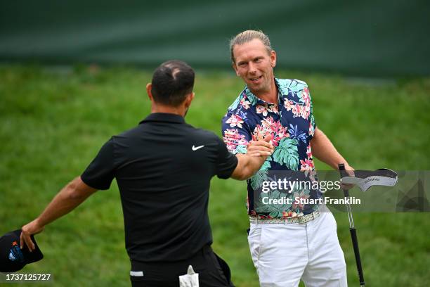 Marcel Siem of Germany shakes hands with Alexander Levy of France on the 18th green on Day Four of the acciona Open de Espana presented by Madrid at...