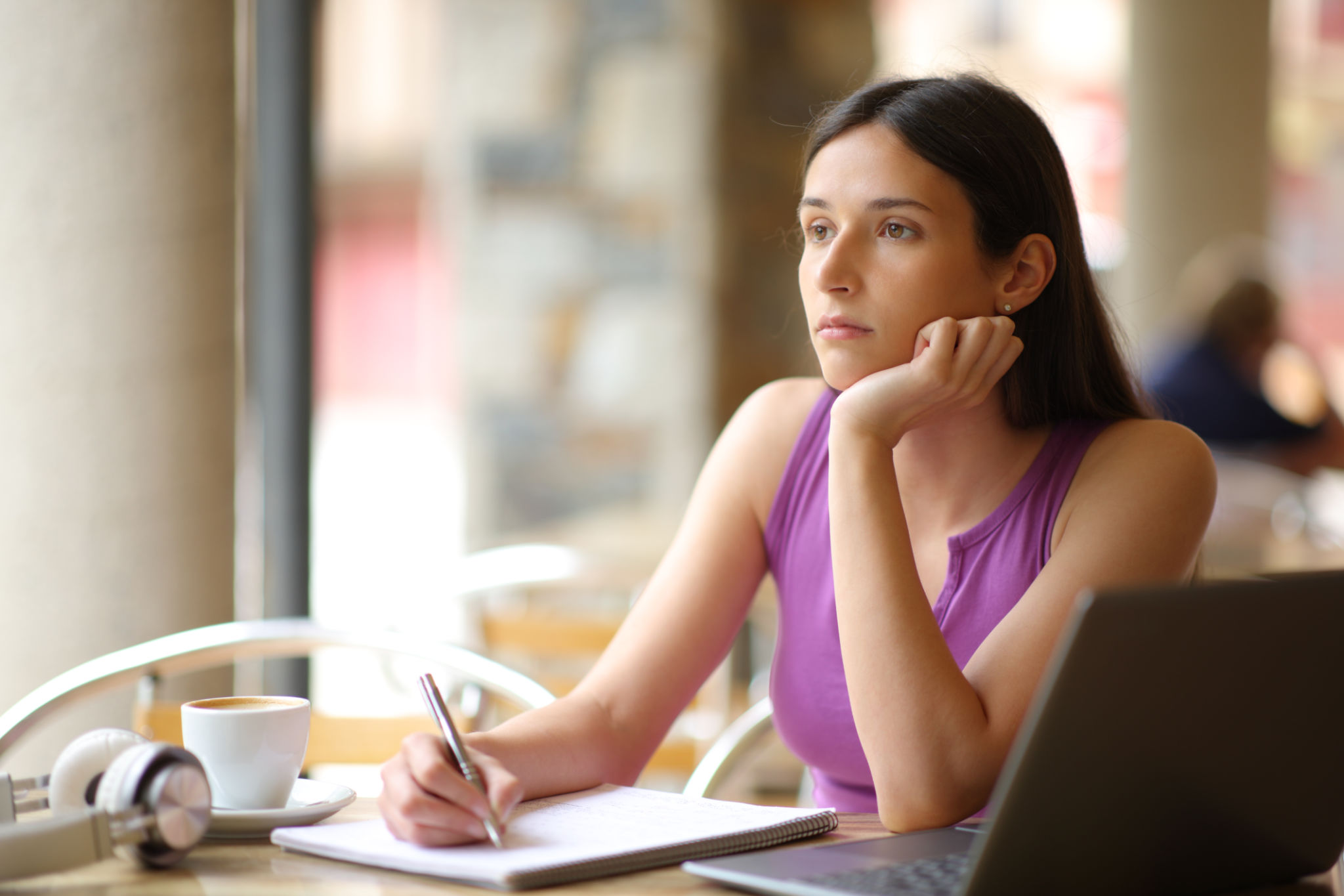 Demotivated student looking away in a restaurant Demotivated student looking away in a restaurant