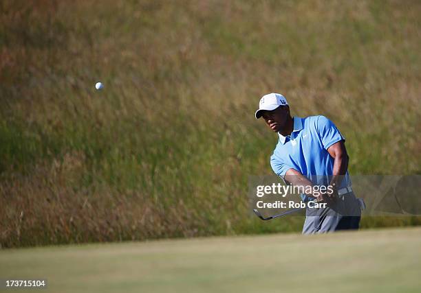 Tiger Woods of the United States plays a chip shot ahead of the 142nd Open Championship at Muirfield on July 17, 2013 in Gullane, Scotland.