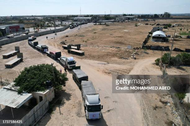 In this aerial view, a convoy of lorries carrying humanitarian aid enters the Gaza Strip from Egypt via the Rafah border crossing on October 21,...