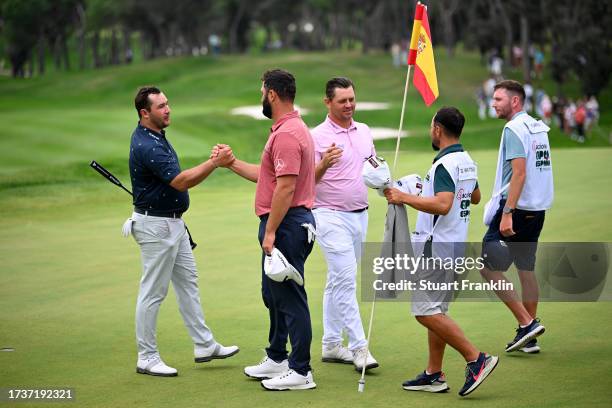 Jon Rahm of Spain, Daniel Van Tonder of South Africa and Thriston Lawrence of South Africa shake hands on the 18th green on Day Four of the acciona...