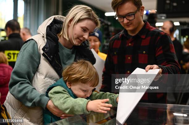 Child casts his parents ballots during Poland's Parliamentary elections on October 15, 2023 in Warsaw, Poland. Poles are voting today to decide...