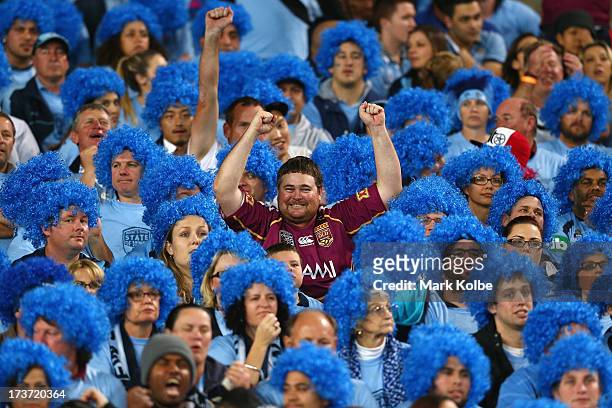 Maroons supporter in the crowd celebrates as they are awarded a try during game three of the ARL State of Origin series between the New South Wales...