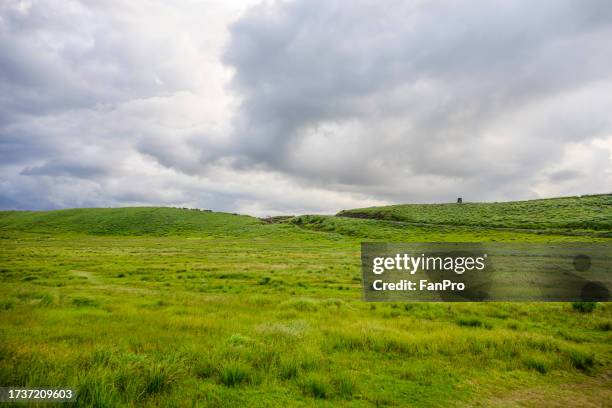 grassland beside aso volcano, green volcanic landscape in aso, kumamoto, japan - japan stock pictures, royalty-free photos & images