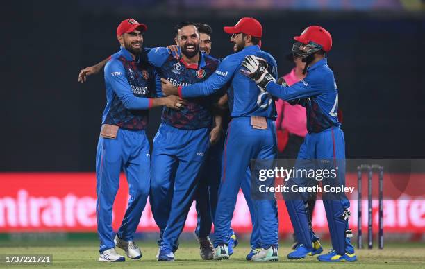 Mohammad Nabi of Afghanistan celebrates the wicket of Sam Curran of England during the ICC Men's Cricket World Cup India 2023 between England and...