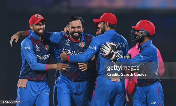 Mohammad Nabi of Afghanistan celebrates the wicket of Sam Curran of England during the ICC Men's Cricket World Cup India 2023 between England and...