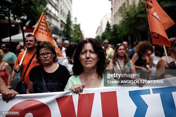 Work of municipality holds a banner against Greek Goverment during a demonstration against new public sector reforms in Athens on July 17, 2013....