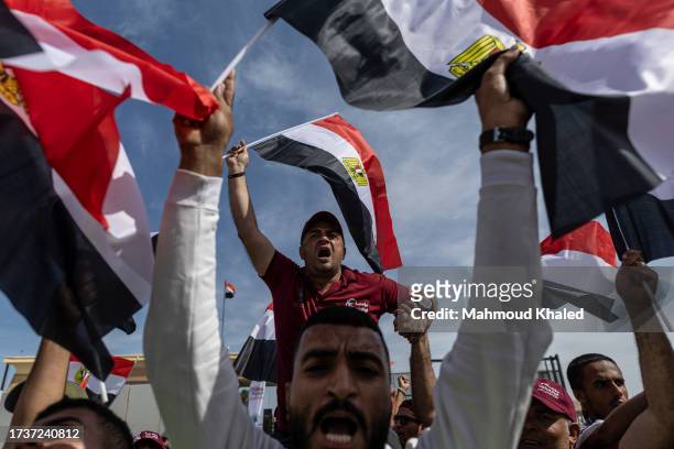Volunteers and NGOs staff celebrate after unloading aid supplies and returning to Egyptian side of border on October 21, 2023 in North Sinai, Egypt....