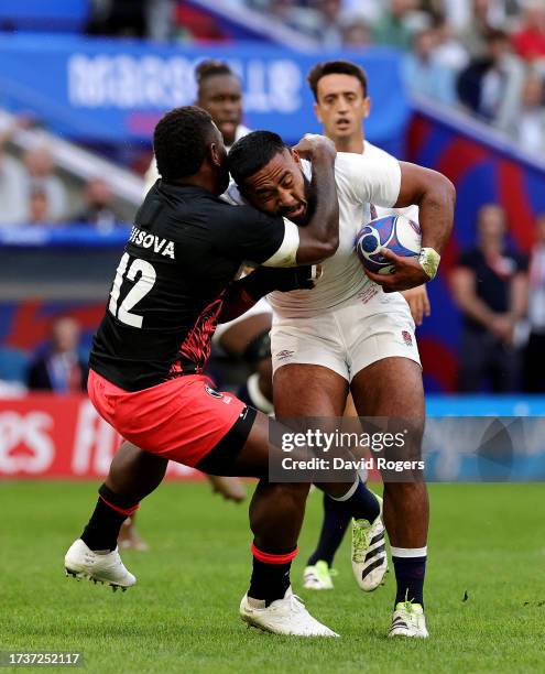 Manu Tuilagi of England is tackled by Josua Tuisova of Fiji during the Rugby World Cup France 2023 Quarter Final match between England and Fiji at...