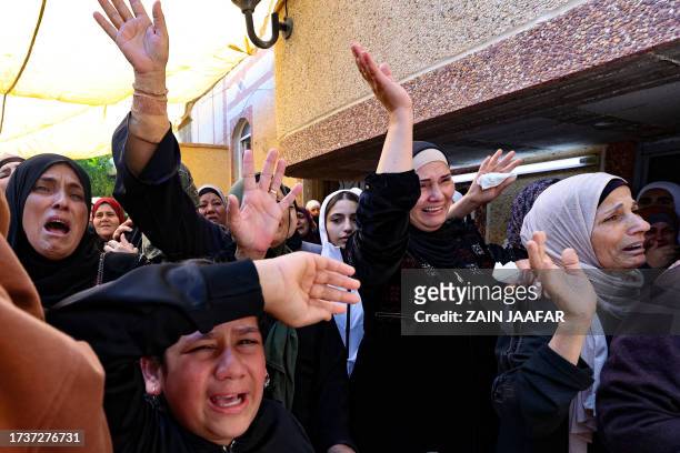 Women mourn during the funeral in the occupied West Bank village of Kafr Qallil of 17-year-old Oday Mansour, a day after he was killed during clashes...