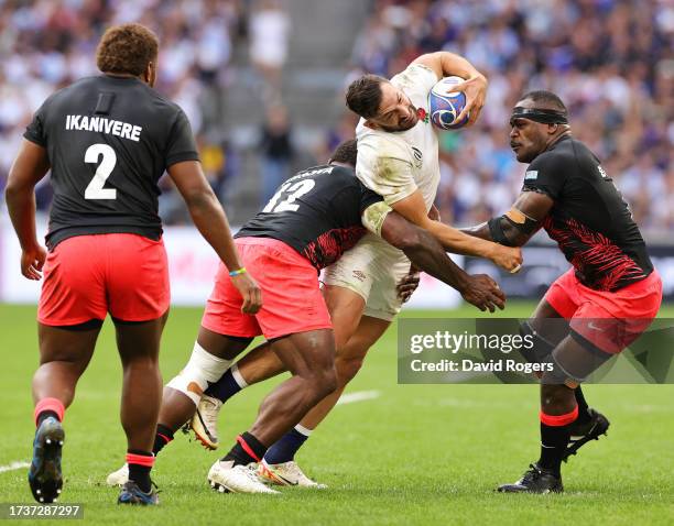 Jonny May of England is tackled by Josua Tuisova and Levani Botia of Fiji during the Rugby World Cup France 2023 Quarter Final match between England...