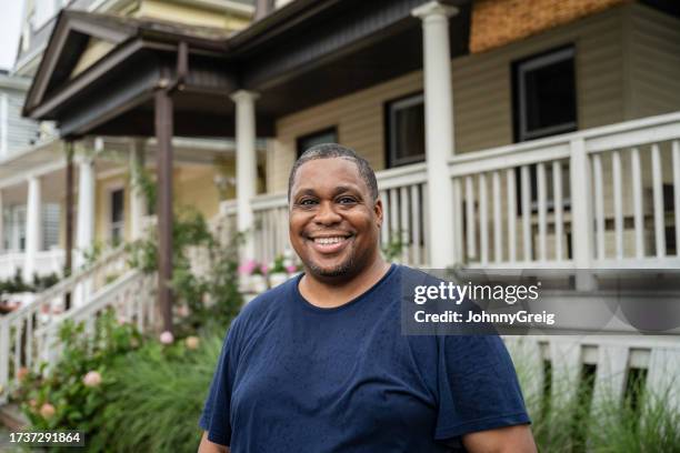 garden portrait of mature black man in blue t-shirt - t 45 stock pictures, royalty-free photos & images