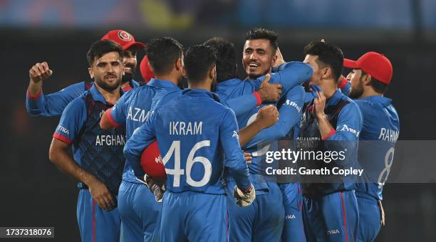 Rashid Khan of Afghanistan celebrates the wicket of Mark Wood of England to win by 69 runs during the ICC Men's Cricket World Cup India 2023 between...