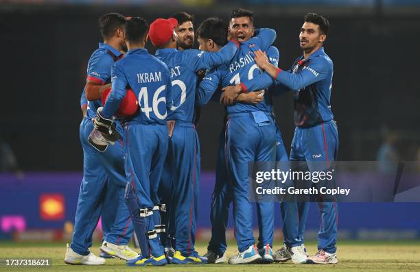 Rashid Khan of Afghanistan celebrates the wicket of Mark Wood of England to win by 69 runs during the ICC Men's Cricket World Cup India 2023 between...