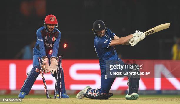 Mark Wood of England is bowled by Rashid Khan of Afghanistan for the final wicket of the match during the ICC Men's Cricket World Cup India 2023...