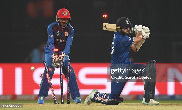 Mark Wood of England is bowled by Rashid Khan of Afghanistan for the final wicket of the match during the ICC Men's Cricket World Cup India 2023...