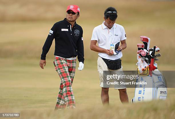 Shingo Katayama of Japan looks on with his caddie ahead of the 142nd Open Championship at Muirfield on July 17, 2013 in Gullane, Scotland.