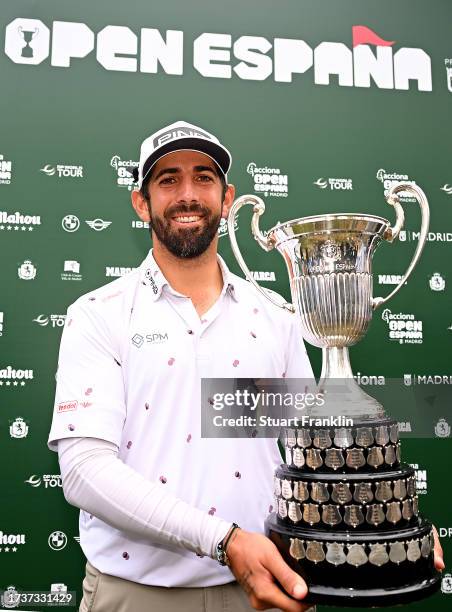 Matthieu Pavon of France is presented with the trophy after winning on Day Four of the acciona Open de Espana presented by Madrid at Club de Campo...