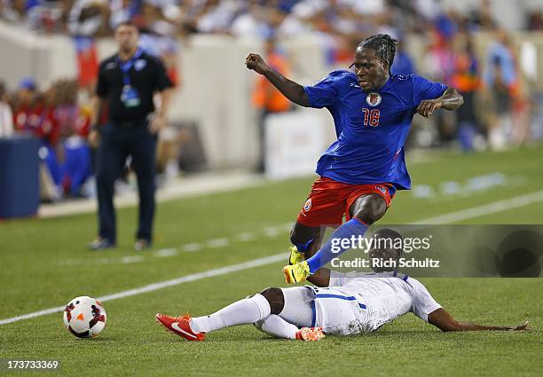 Forward Leonel Saint Preux of Haiti is challenged by defender Juan Carlos Garcia of Honduras during a 2013 CONCACAF Gold Cup soccer match on July 8,...
