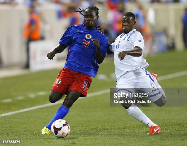 Forward Leonel Saint Preux of Haiti is challenged by defender Juan Carlos Garcia of Honduras during a 2013 CONCACAF Gold Cup soccer match on July 8,...