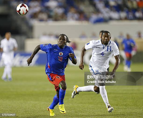 Forward Leonel Saint Preux of Haiti battles defender Johnny Palacios of Honduras for control of the ball during a 2013 CONCACAF Gold Cup soccer match...