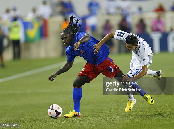 Forward Leonel Saint Preux of Haiti battles midfielder Edder Delgado of Honduras for control of the ball during a 2013 CONCACAF Gold Cup soccer match...