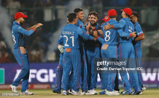 Rashid Khan of Afghanistan celebrates the wicket of Mark Wood of England to win by 69 runs during the ICC Men's Cricket World Cup India 2023 between...