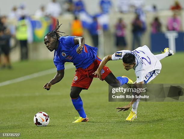 Forward Leonel Saint Preux of Haiti battles midfielder Edder Delgado of Honduras for control of the ball during a 2013 CONCACAF Gold Cup soccer match...