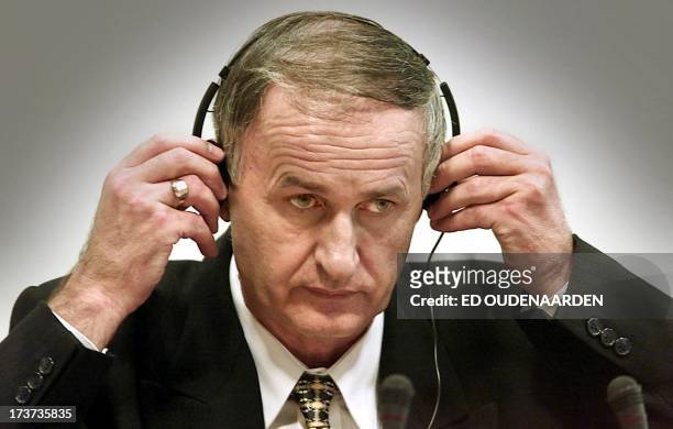 Former Bosnian Serb general Radislac Krstic accused of genocide for the 1995 Srebrenica massacre, puts on headphones on during his trial at the UN...