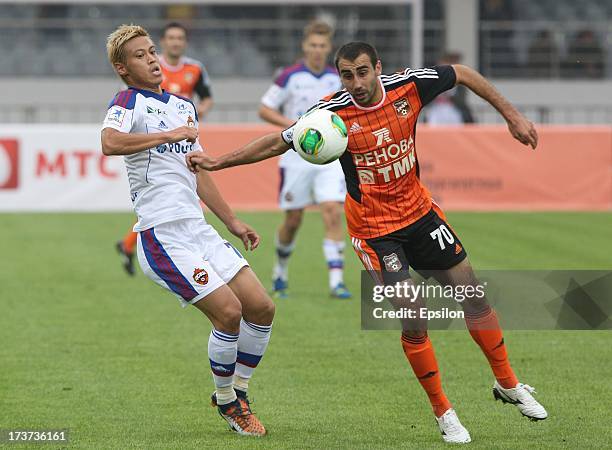 Keisuke Honda of PFC CSKA Moscow competes for the ball with Nikolay Safronidi of Ural Ekaterinburg during the Russian Premier League match betweenn...