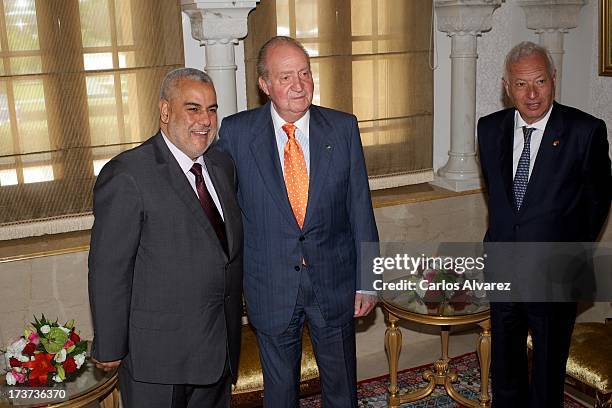 King Juan Carlos of Spain and Spanish Minister of Foreign Affairs Jose Manuel Garcia Margallo receives Moroccan President Abdelilah Benkiran at the...
