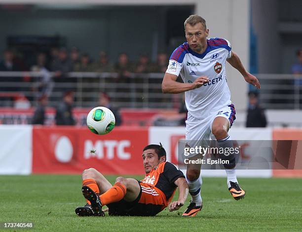 Spartak Gogniyev of FC Ural Sverdlovsk Oblast is challenged by Vasili Berezutski of PFC CSKA Moscow during the Russian Premier League match betweenn...