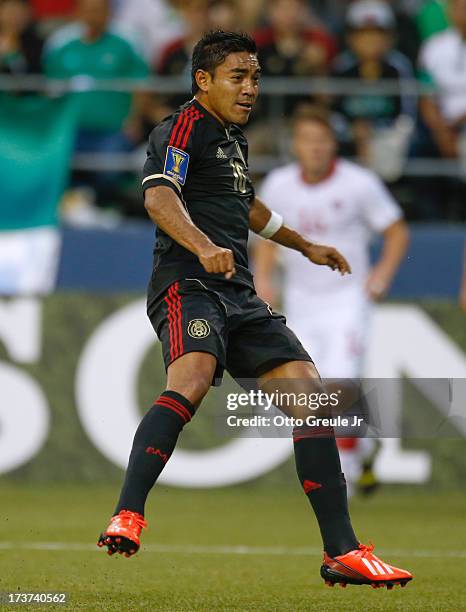 Marco Fabian of Mexico follows the play against Canada at CenturyLink Field on July 11, 2013 in Seattle, Washington.