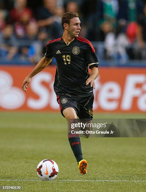 Miguel Layun of Mexico dribbles against Canada at CenturyLink Field on July 11, 2013 in Seattle, Washington.